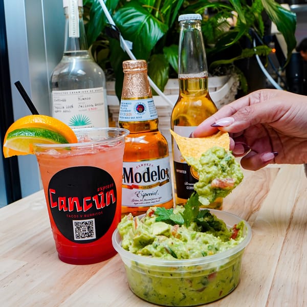 Cancun Express margarita, Modelo beers, tequila, and a hand dipping a chip into guacamole.